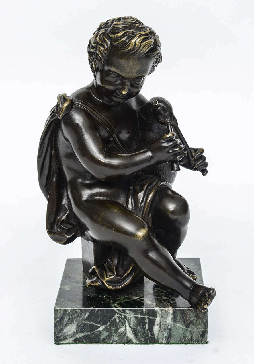 After Jean-Baptist Pigalle (1736-1785) a French sculptor renown for his designs of children at play.

Mounted on a new green marble base.
