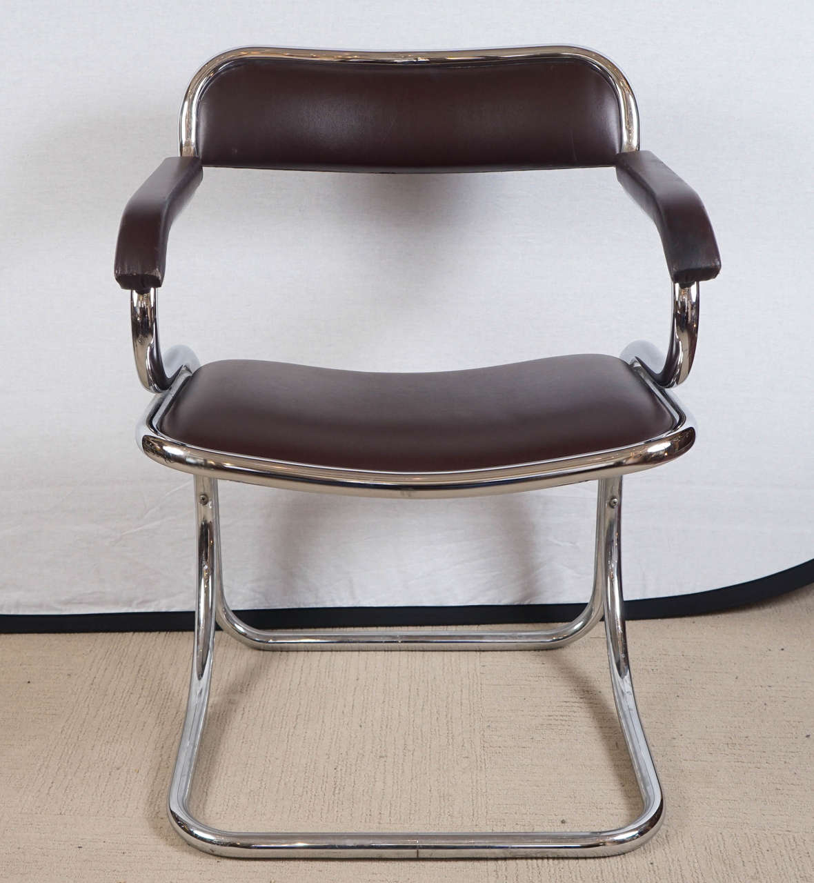 A pair of cantilevered leather and chrome chairs.