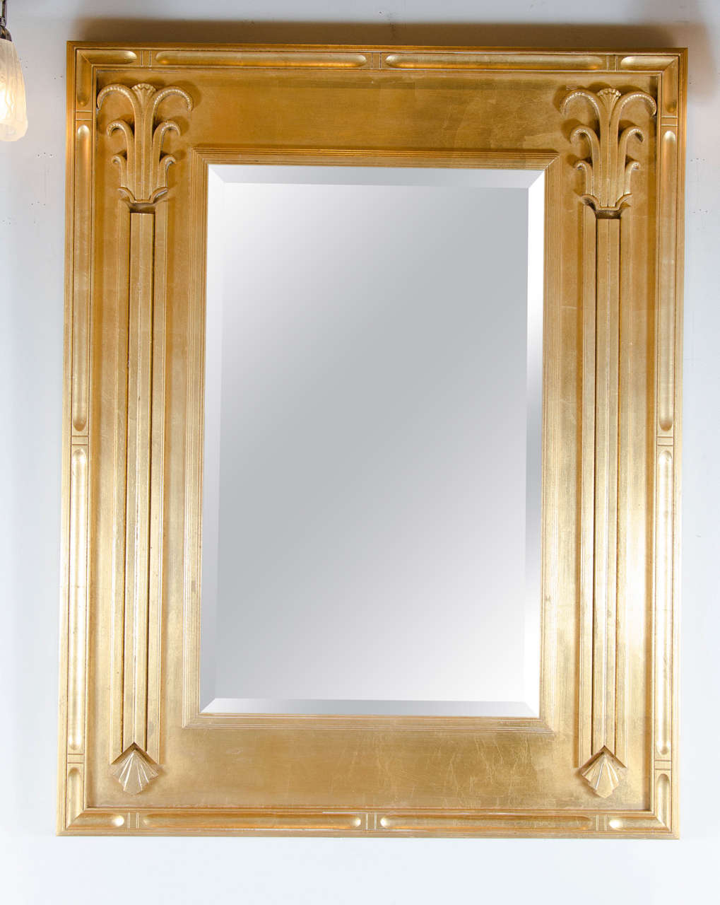 This phenomenal Art Deco 24k yellow Gilt mirror is a rare beauty in it's form. Designed with skyscraper detailing, and it's intricate details, it is a statement piece of grandeur. It is in excellent condition and would look great in any room or