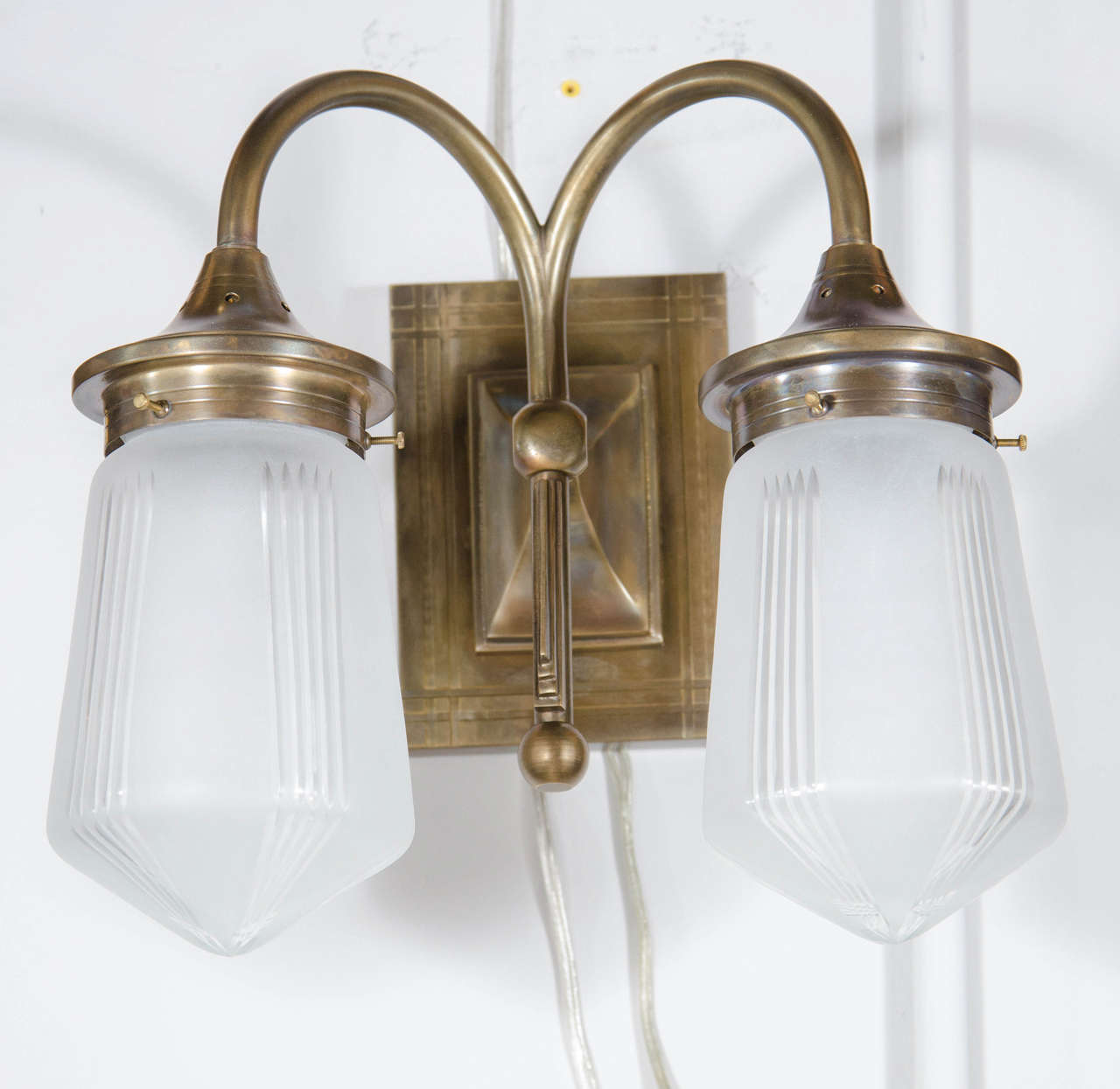 This stunning pair Art Deco style sconces features two etched globes with frosted glass and bronze fittings.  They would look great in any room or decor.  They are in excellent condition and have been completely rewired. Could also be used over a