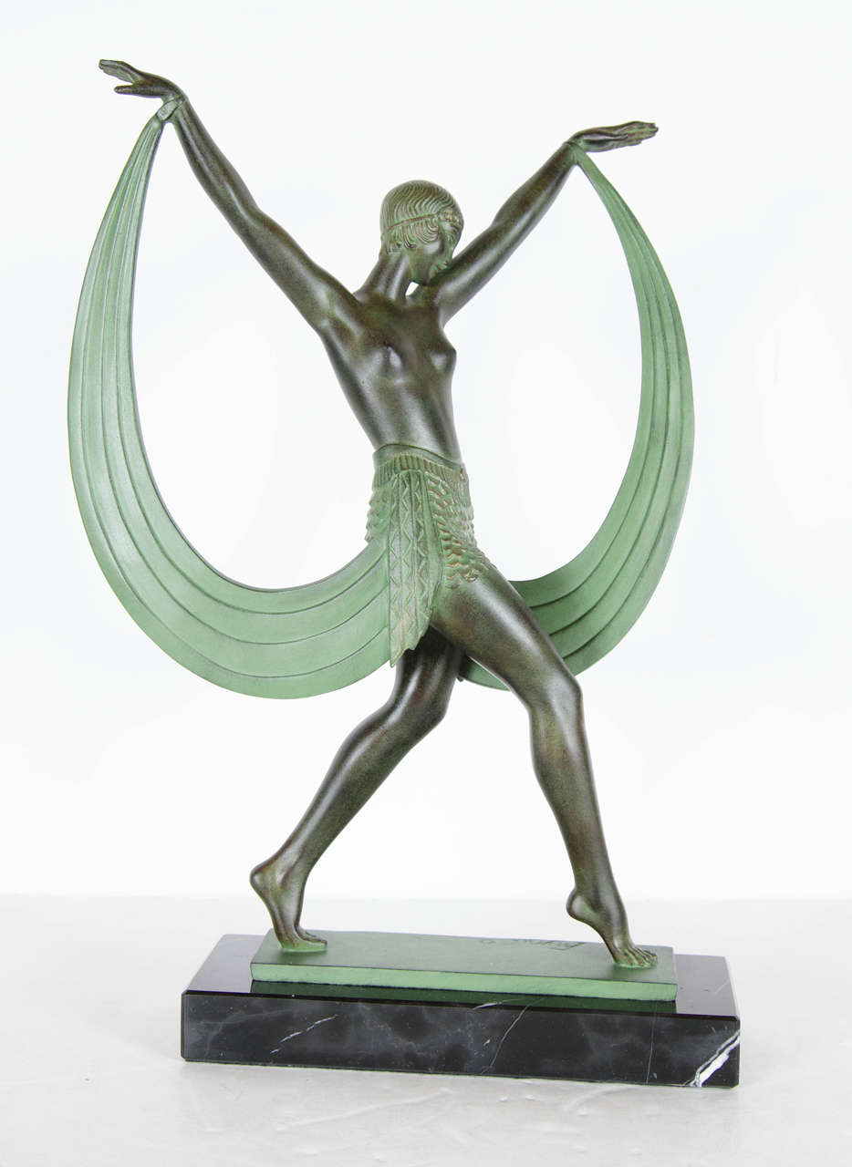 French Le Verrier bronze statue by Pierre Le Faguays (signed Fayral - his pseudonym). She is a flapper dancer in Art Deco dress produced by the Le Verrier foundry in the early 1930s. Mounted on a exotic black marble base and signed Fayral to the