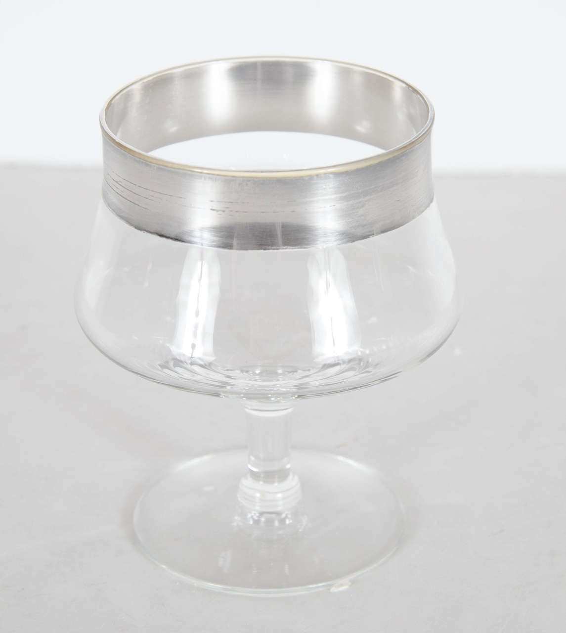These ultra chic desert glasses feature a thick rim of sterling silver banding overlaid on the glasses by the noted designer Dorothy Thorpe. These would be also great for ice-cream or sorbet.