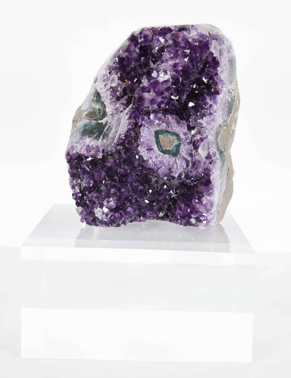 This exceptional amethyst rock specimen features an intricate design of crystalline structures with a myriad of purple, lilac, and lavender hues. It's oblong three dimensional shape showcases it's complex structure and it's free standing thick