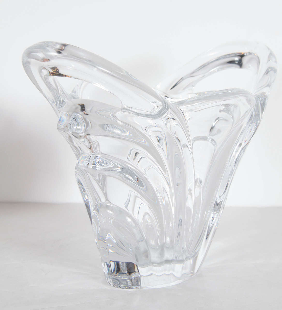 This stunning vase features ribbed and fluted detailing with a splash effect all executed in fine handblown crystal. It has an Art Deco style reinterpreted in a modernist manner. The vase also bears the Art Vannes (made in France) stamp on the