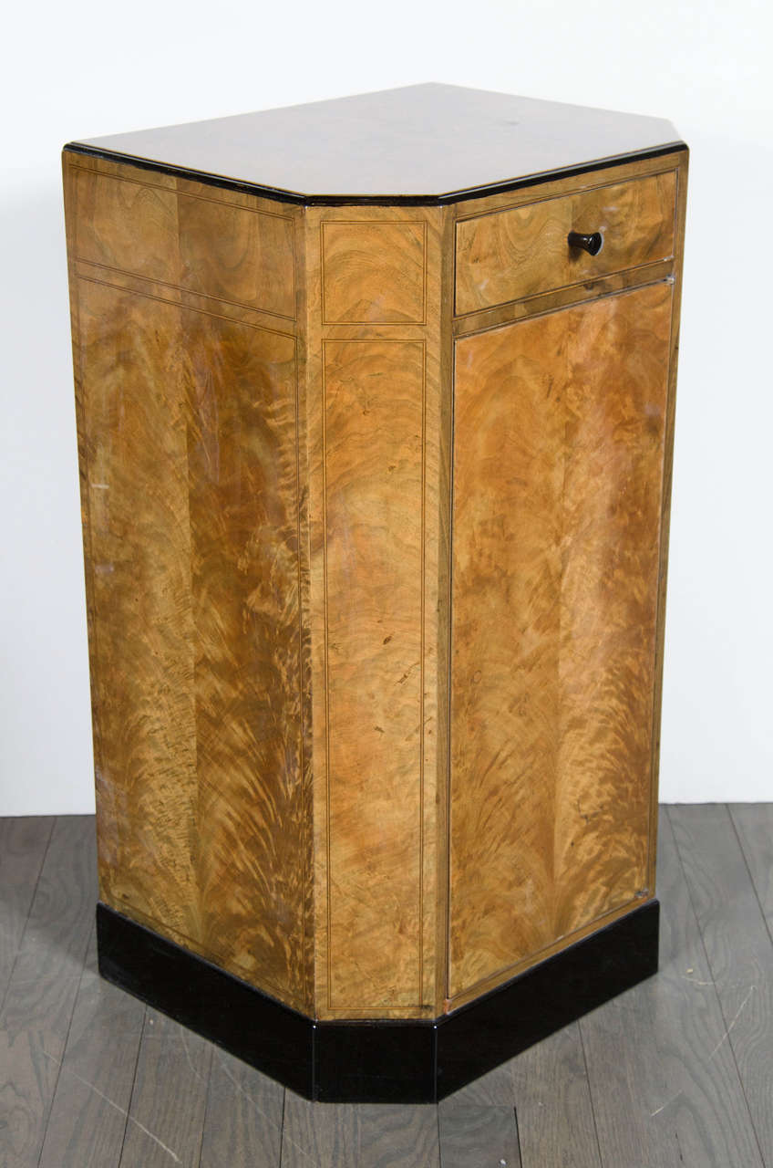 Exquisite pair of Art Deco Skyscraper style night stands / end tables in book-matched exotic burled Elm with inlay details and black lacquer accents.  This stunning pair of French Art Deco night stands / end tables are showcased in a stunning