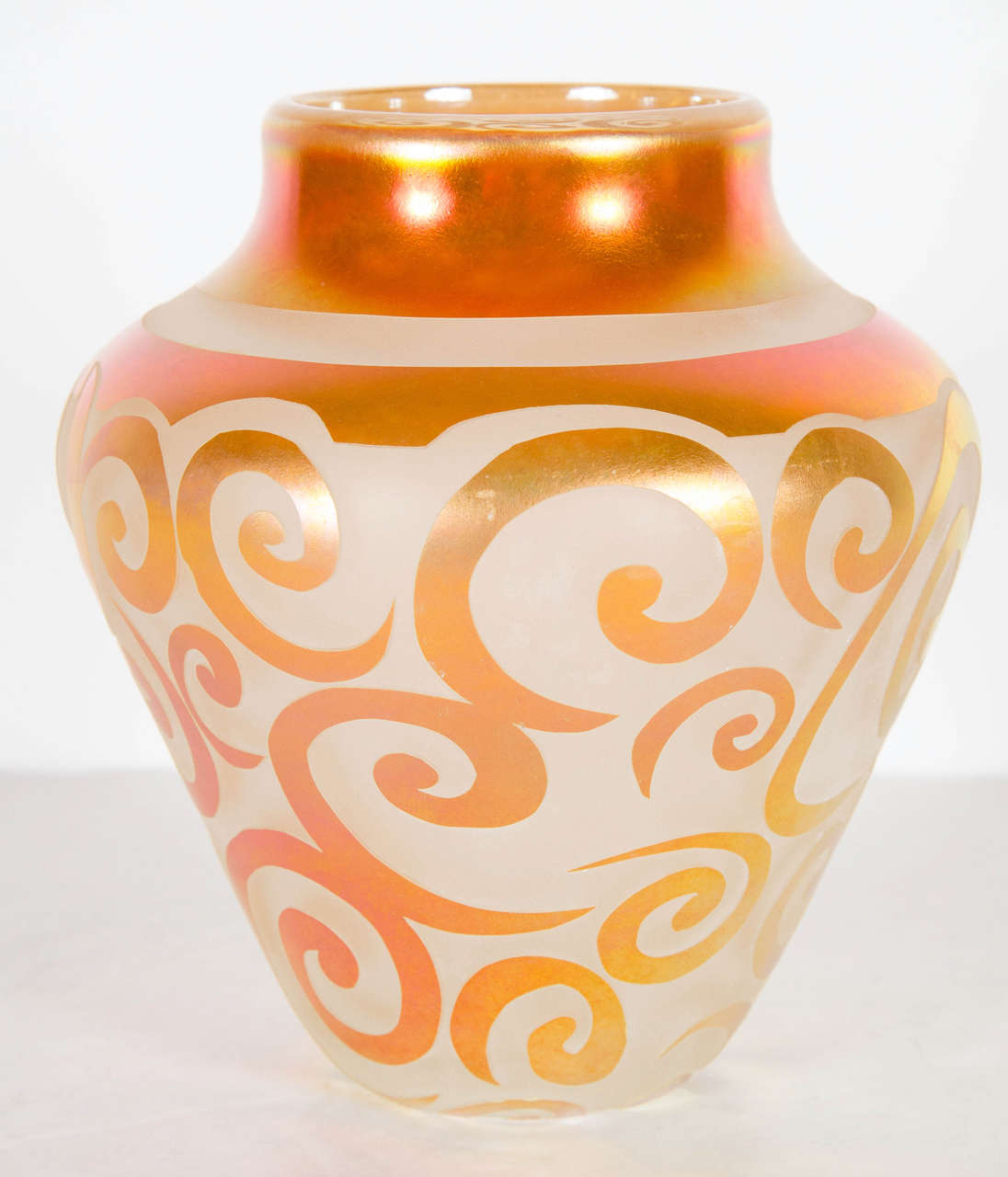 This very sophisticated vase is made of hand blown relief glass in hues of iridescent copper with a scroll design mist a frosted glass background. The vase is signed, numbered and dated 1998 and the edition number is 21/500 .Great as a decorative