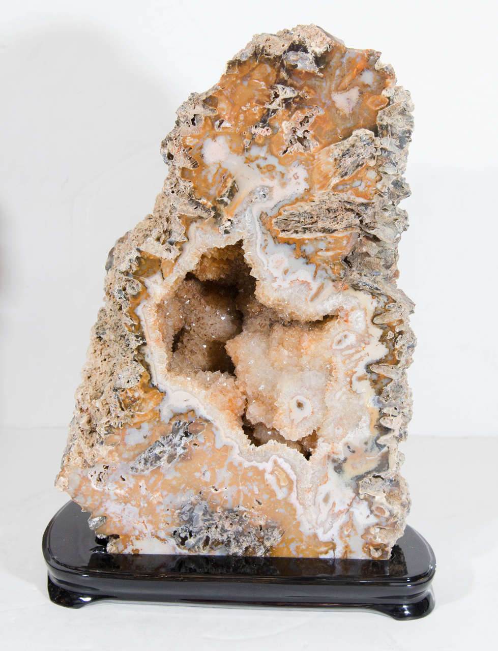 This stunning rock specimen features citrine crystals in shades of pearl, umber, and grey.  With it's beautiful structure and ebonized walnut base, it is a unique decorative accent and would look magniifcent in any room or decor.