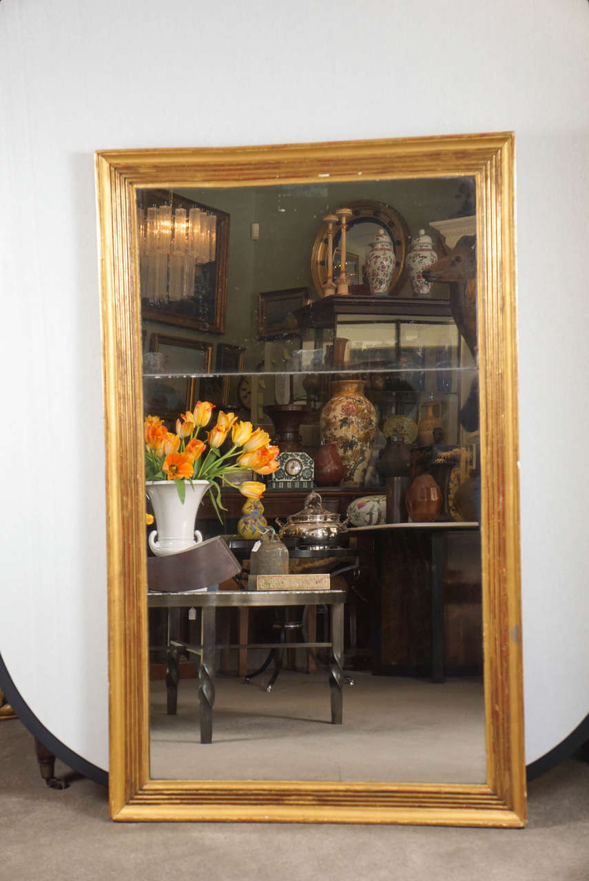 French giltwood frame with split glass.