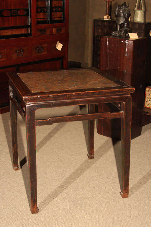 Chinese square side table constructed of jumu (elm) wood and with top inset panel of pudding stone. Puddingstone, a conglomerate rock made up of a mixture of different, irregular sized grains and pebbles held together by a finer matrix, was a
