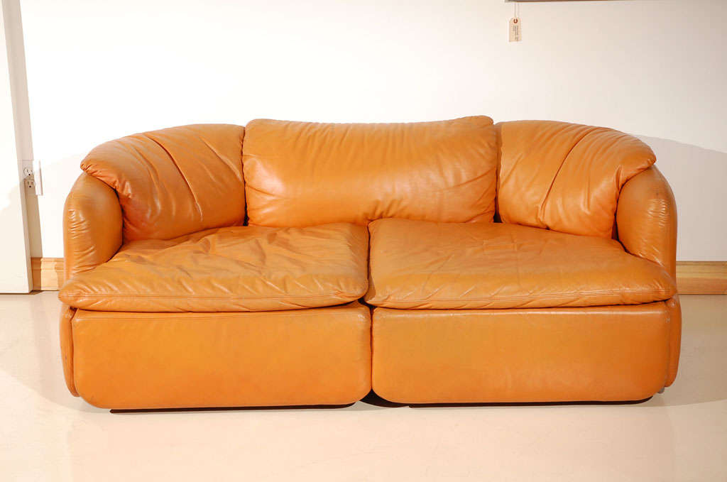 Small comfortable sofa in camel leather.  Designer by Alberto Roselli for Saporiti.  Matching chair also available.