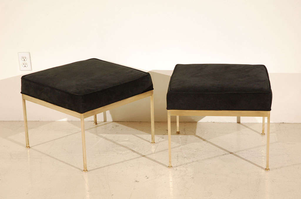 Solid brass base ottomans in chocolate suede. The round feet are levelers.