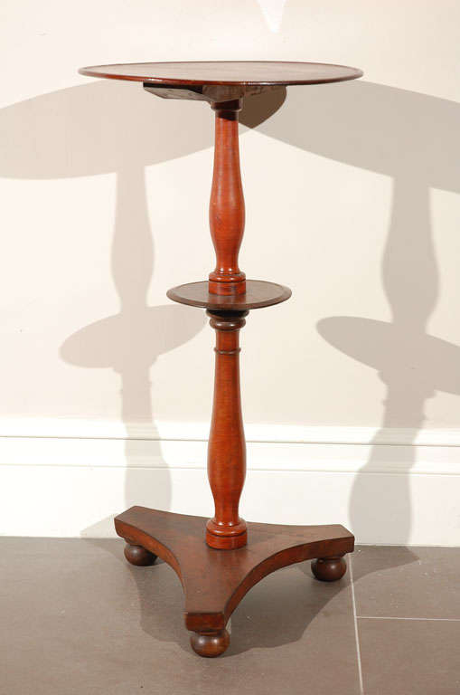 Graceful English, round mahogany stand with 3 feet.