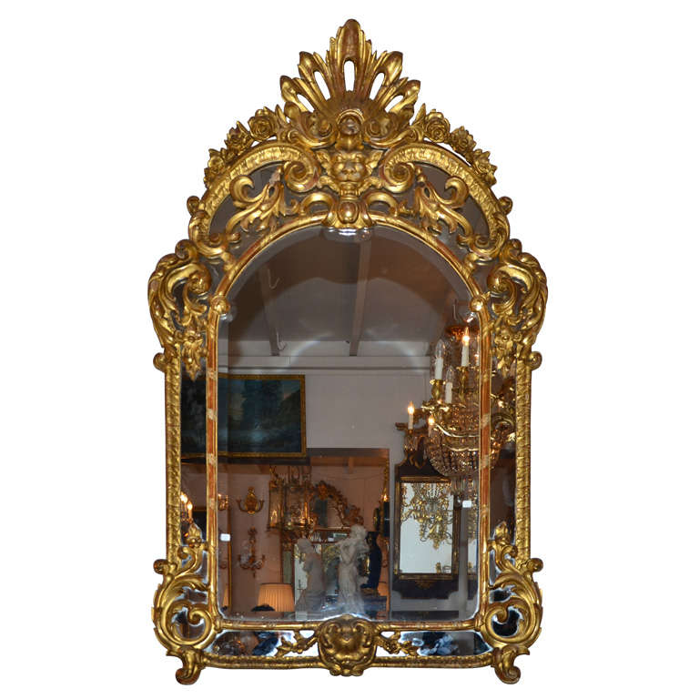 Very inusual gilded and carved wood mirror, Régence Style. For Sale