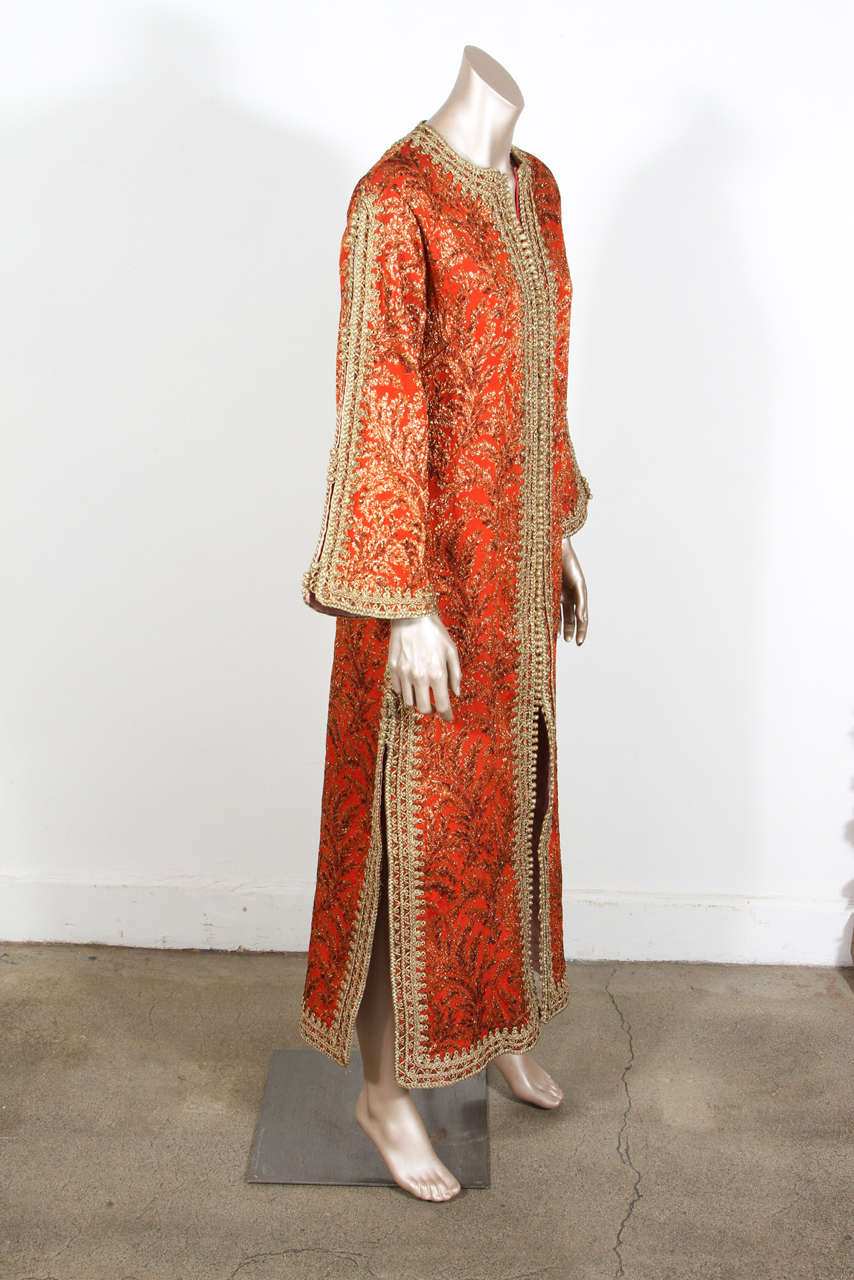 Vintage Designer Moroccan Silk Brocade Hand-made Caftan, 1970's.
Golden Brocade Silk Moroccan caftan with orange and red deep colors, the kaftan is embroidered and embellished entirely by hand, super-luxe designer kaftan. One of a kind evening