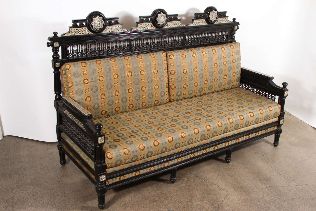 Middle Eastern Moorish black settee with spindle and ball design and pearl inlay with triple arch inlaid with mother of pearls and mucharabie intricate and fine work.
Newly reupholstered.
Settee is : 72