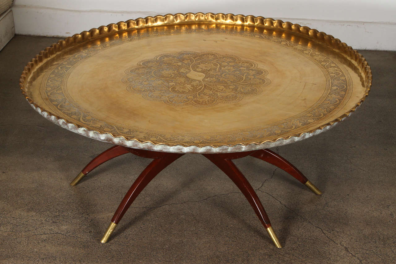 Large Mid Century Modern engraved and embossed large 45 inches round Moroccan brass tray table.
Polished brass tray, very good condition, standing on folding mahogany base with six legs.
Very hard to find 45 inches diameter large Moroccan