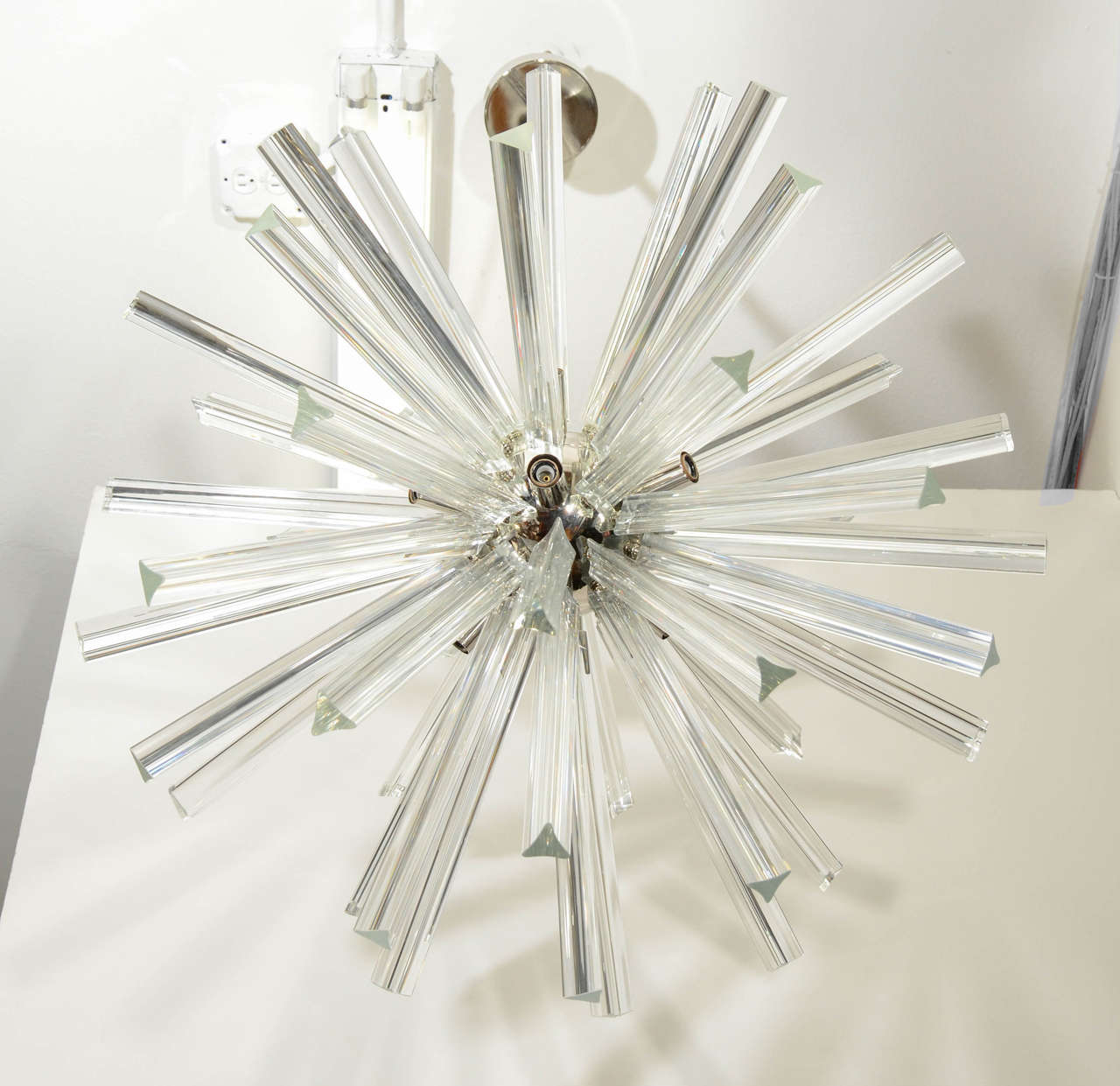 A sputnik or starburst form chandelier with chrome ball center and clear glass prisms