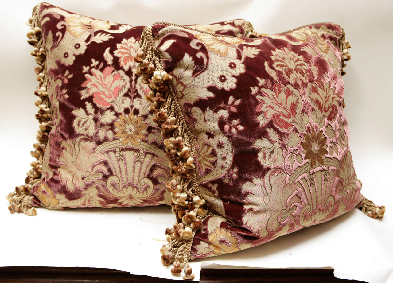 Pair of Italian cut silk velvet pillows with floral basket motif. The pillows are backed in silk velvet and have silk tassel trim.