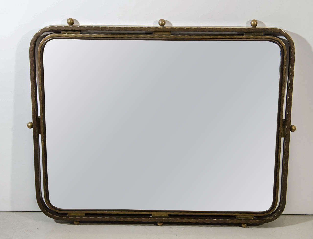 Designed in the late deco period of Streamline Moderne this solid brass mirror provides a look at the evolution of design. Created in the late 1930s this mirror shows how Streamline moderne with its curves and clean lines bridge the gap between Art
