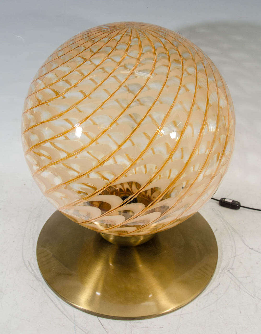 A vintage circa 1950s Italian blown glass globe table lamp or pendant with new brass fitting. Glass globe is brass and copper colored with a curved stripe pattern. Canopy is newly rewired.

In good vintage condition with age appropriate wear.
