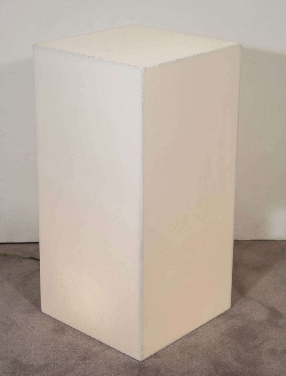 A 20th century white acrylic rectangular column illuminating pedestal. Good condition with some wear to the edges and some scratches.