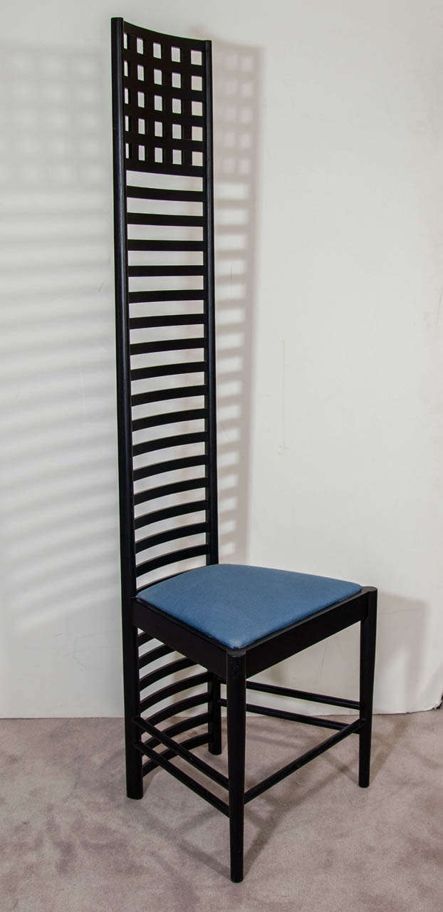 A vintage ladderback Hill House chair with ashwood frame stained black designed by Charles Rennie Mackintosh and made by Cassina. Seat upholstered in blue linen.

Good condition with age appropriate wear.