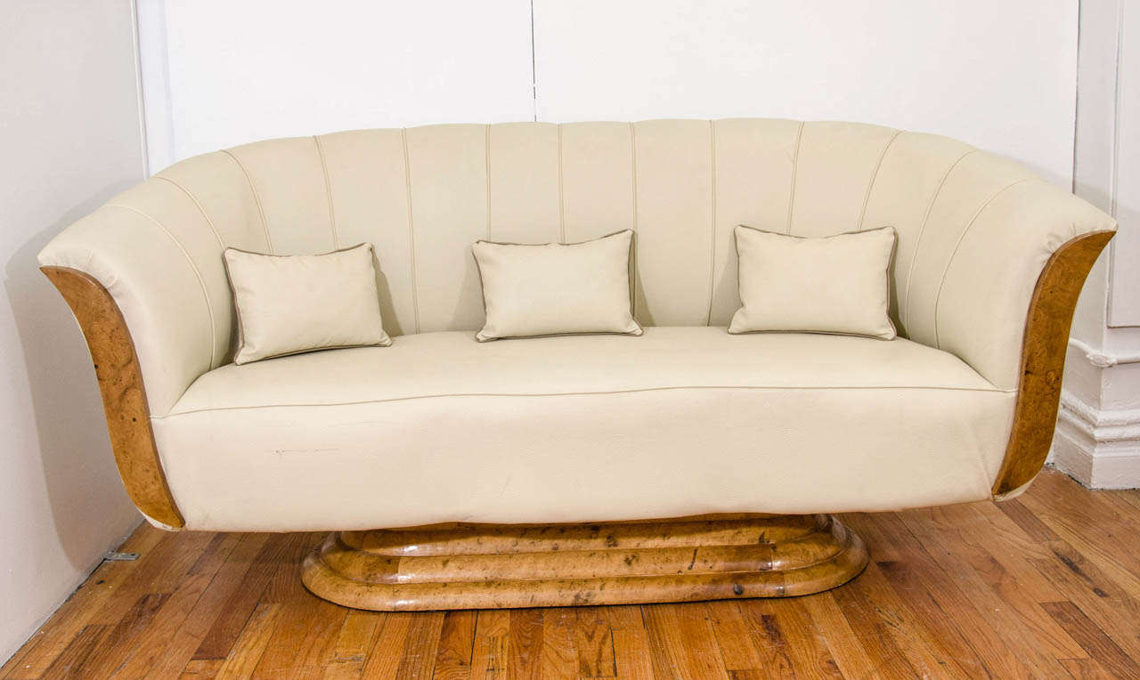 An Art Deco burled wood and cream color leather parlor set. Includes a settee, and two armchairs all with fanned backs and patchwork pedestal bases.

Good vintage condition, minor cracks on wood and spots on leather

Reduced from: $9500