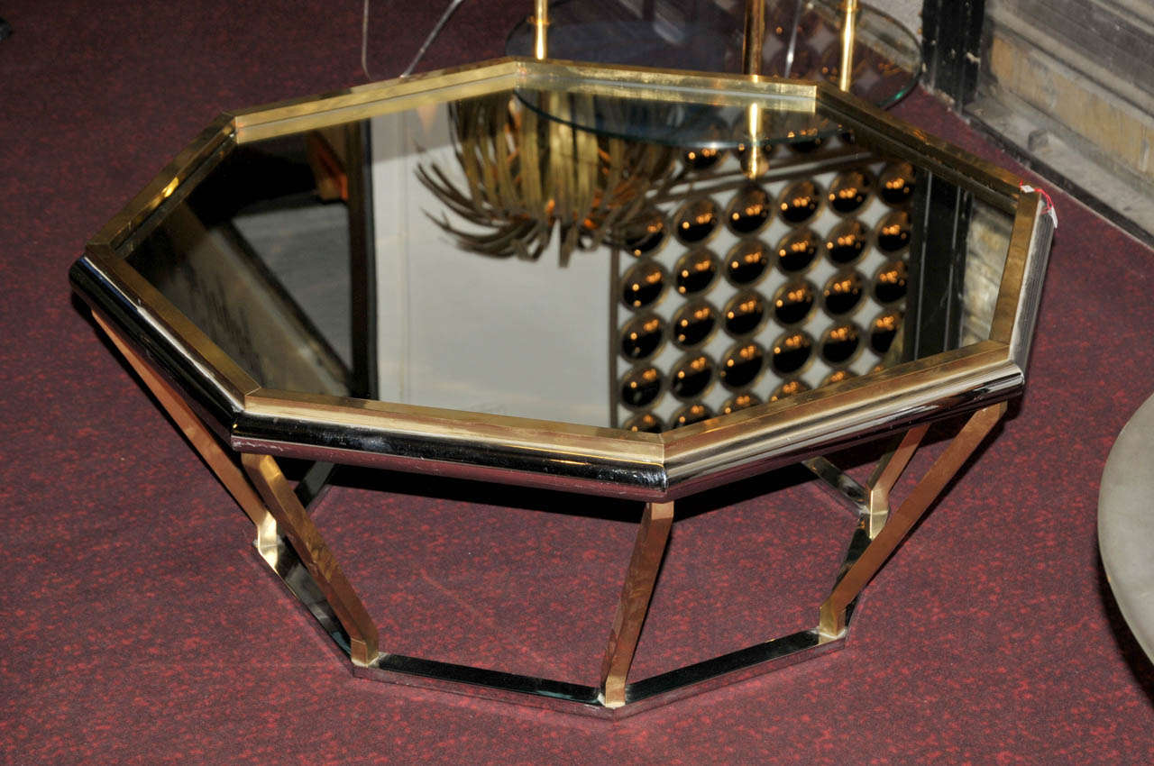 1970's coffee table in brass and chrome steel. Octogonal mirror top. Good condition. Normal wear consistent with age and use.