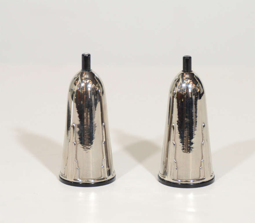 This rare set of shakers feature a stylized chrome body with stepped skyscraper design with bakelite fittings.