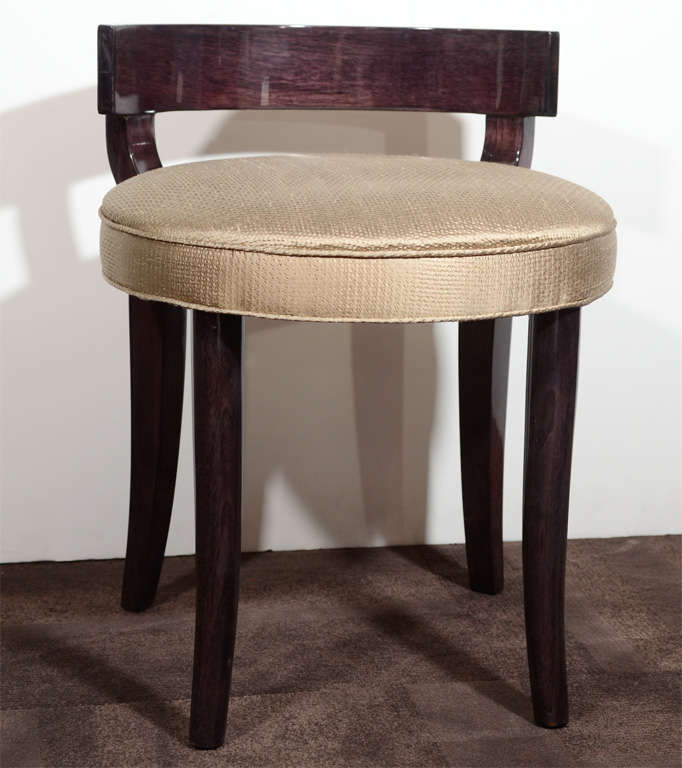 Ebonized mahogany and newly upholstered in a metallic gold textured fabric. Curved Klismos back detail. With tapered legs.