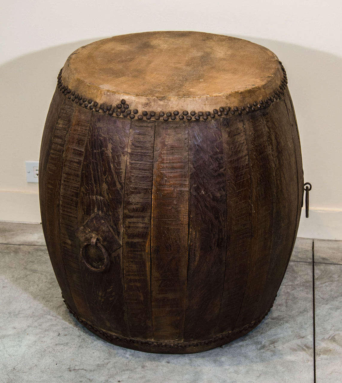 A large nicely weathered elm drum with original skin and hardware. Works perfectly as a side table.  From Shanxi Province , c. 1850.
M906