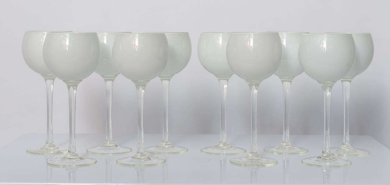These cased glasses,  hand blown in the 1960's  by Carlo Moretti, will bring an elegant European touch  to your table. The white and clear tones will match any calories you serve. Simple and Elegant.