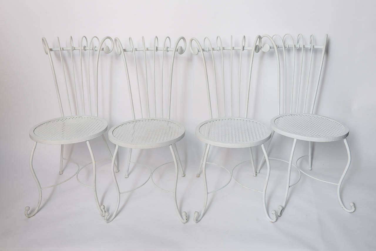 Born of elegance, this glamorous Hollywood Regency white wrought Iron set will add a stunning accent to your interior or garden.  I have read that these chairs were designed by Dorothy Draper, a famous designer in the 40s.  If they were, or if these