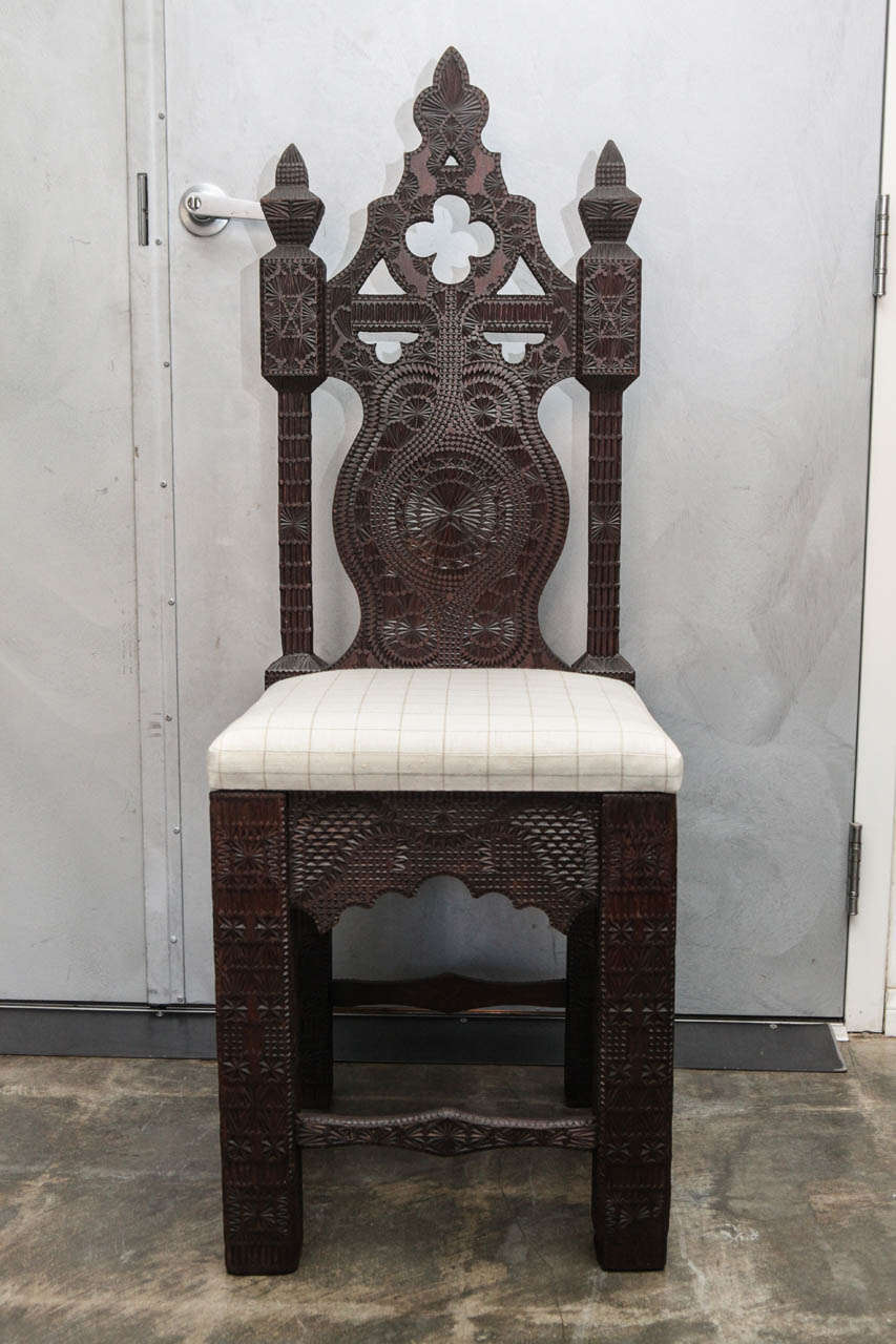 This is an exquisite example of Turkish wood carving techniques developed  since the 1100's. The chair has intricate carved patterns in duplicating geometric variations. The chair has a well shaped tall back two wonderfully carved finials. The four