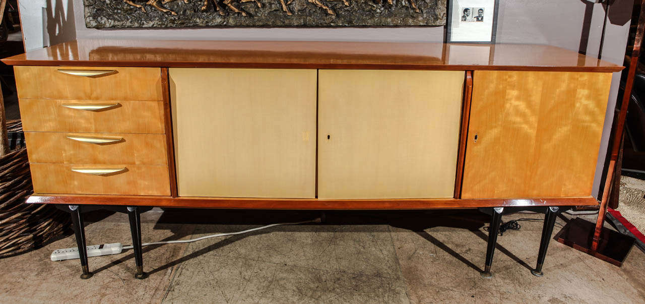 A gorgeous mid century Italian credenza/buffet in sycamore and fruitwood. Brass hardware.