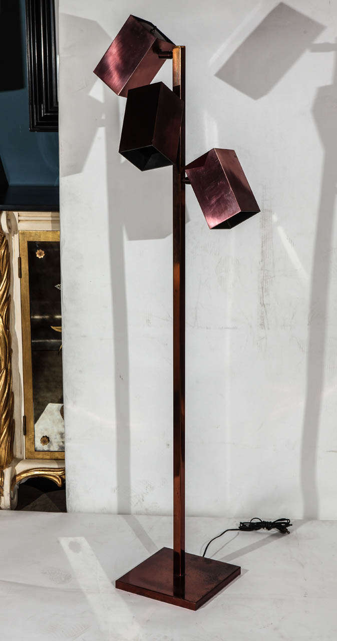A midcentury vintage copper finish floor lamp by Koch & Lowy. Has three-light canisters.
