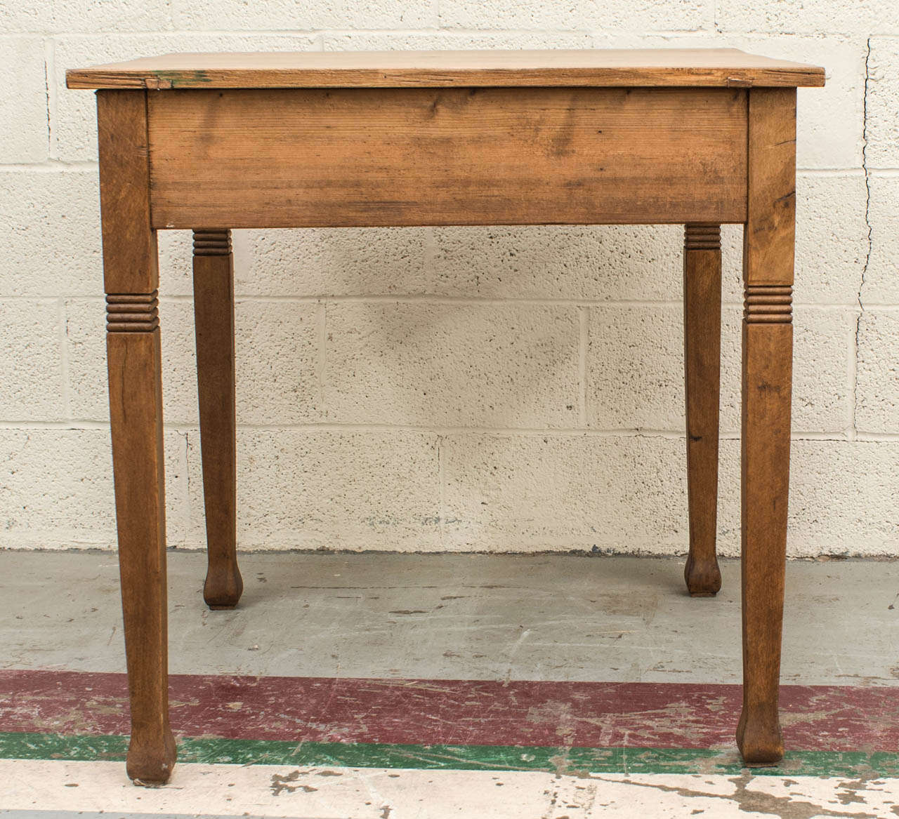 A great little table of perfect proportions for card games, kitchen use or as an occasional table almost anywhere.  The pine top and aprons are supported by four beechwood legs featuring reeded incisions and charming flared feet.