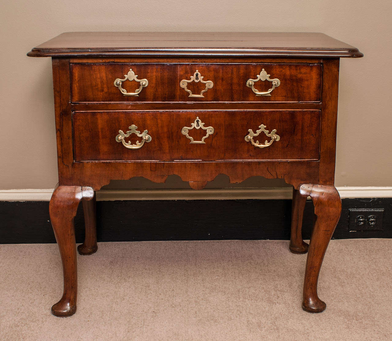 Excellent proportions - rich mellow patina to the beautifully grained mahogany - graceful cabriole legs with pad feet - two drawers - moulded oversized tray top -- hardware appears to be original.