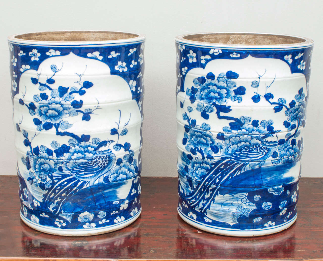 Pair of impressive ribbed jars with traditional Phoenix and Peony motif. Handcrafted in the Jingdezhen region of China, home of the Imperial kilns.