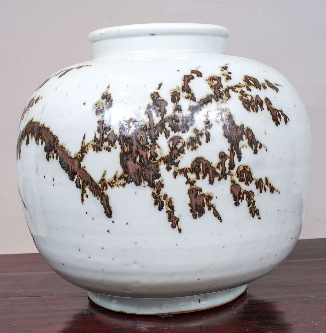 Brown and white abstracted design on 20th century round vessel.