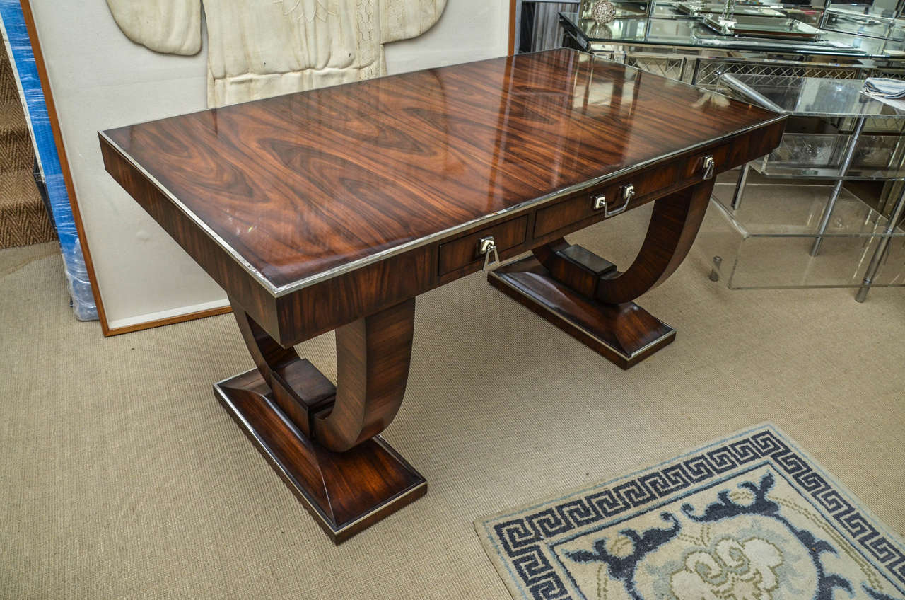 Striking Deco style walnut partners desk with three identical working drawers on both sides. The desk is walnut with chrome trim.