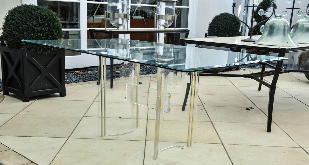 Mid-Century glass top dining table with Lucite base. The glass top is beveled.