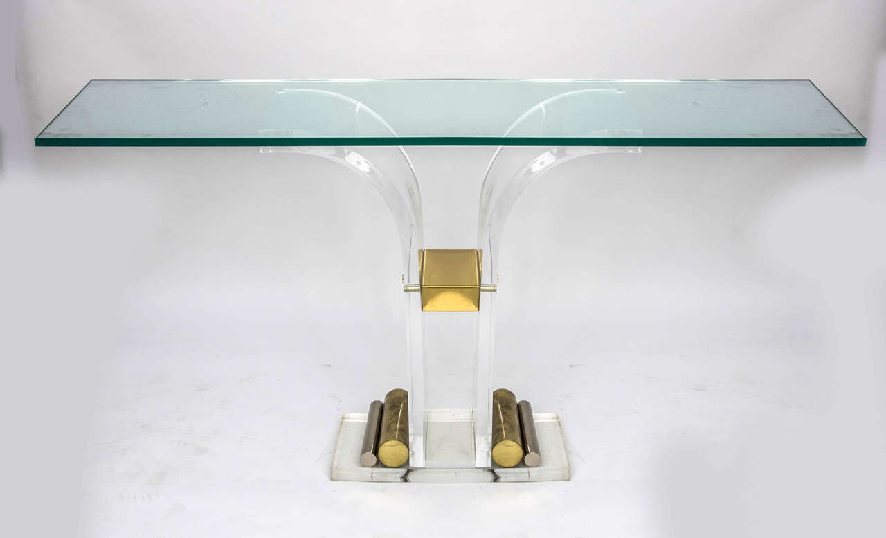 Console table of curved Lucite with brass and steel details and glass top. Probably 1970s, France.

An elegant piece the glass simply resting on the Lucite frame. Dimensions reflect the size of the glass but you have the option to replace the