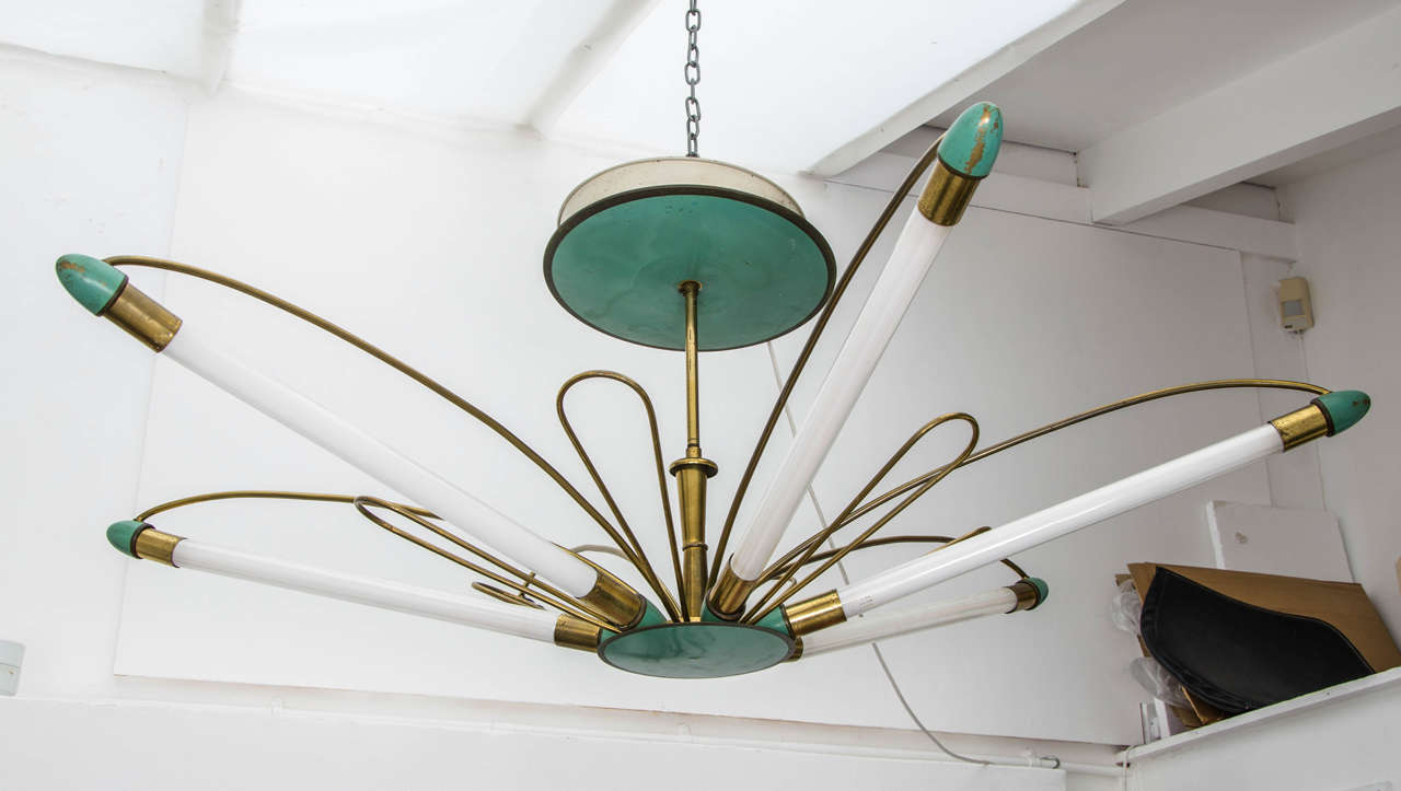 Spectacular fluorescent flower-shaped chandelier with brass frame and green enamel detailing. Netherlands 1950s, designer unknown.

Dimensions: Diameter 150cm x H 60cm (excluding optional chain).