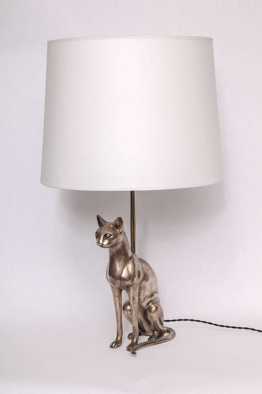 A pair of 1920s silvered bronze sculptural Siamese cat table lamps.