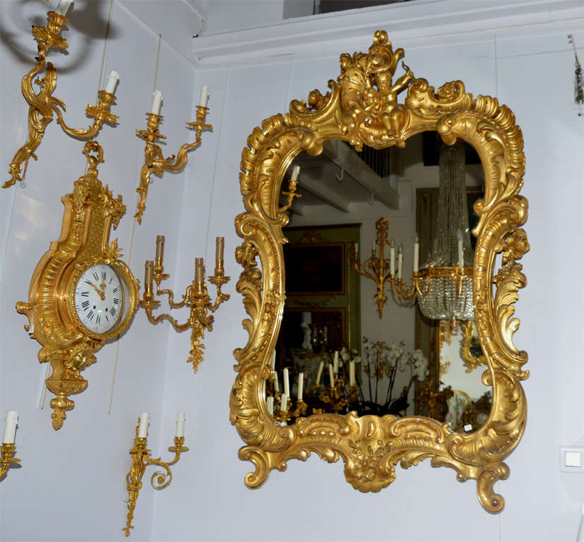 very well carved shapely gilded wood mirror.