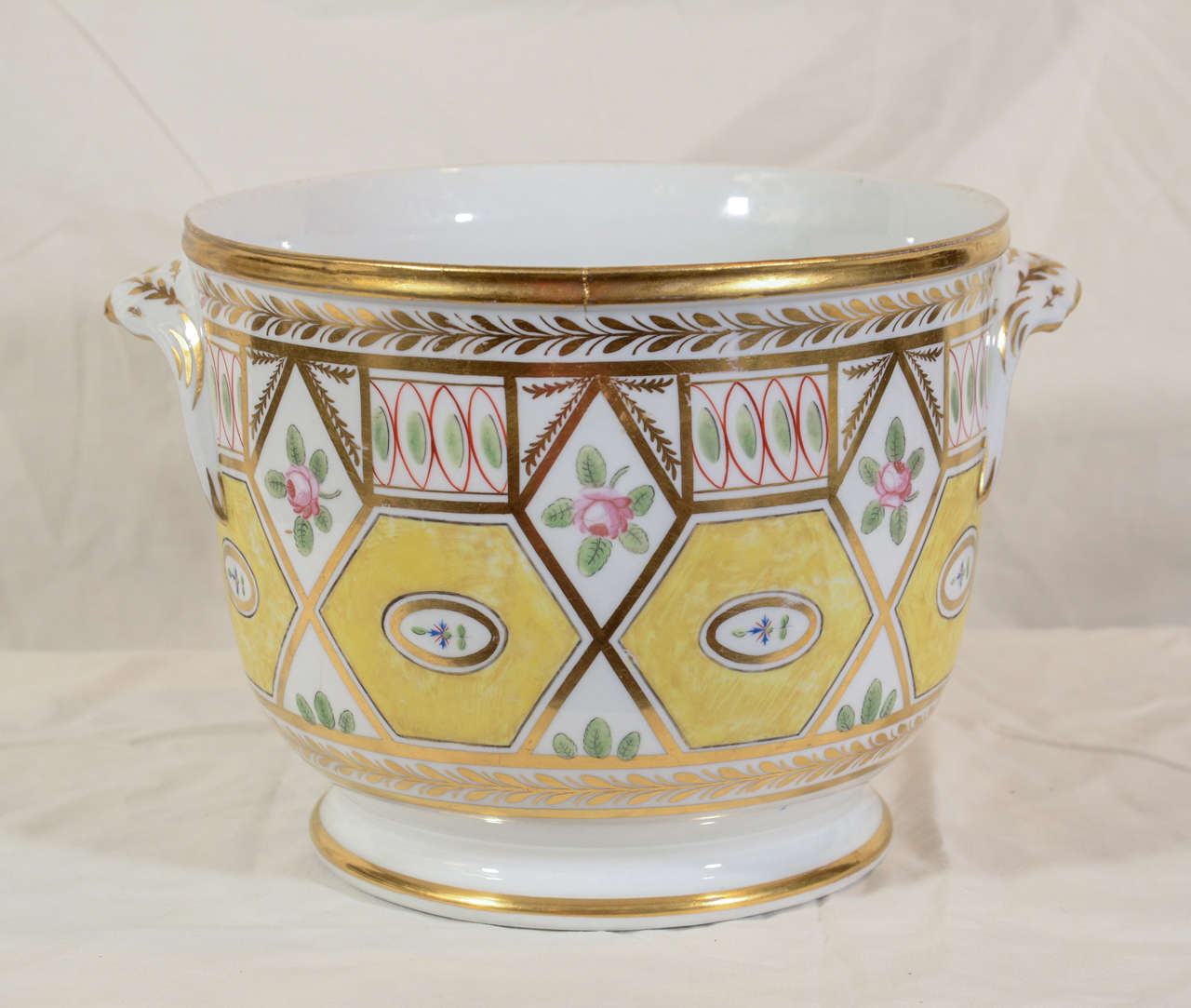 An early 19th century, Coalport wine cooler in the remarkable Church Gresley pattern with yellow ground hexagons, roses, and exceptional gilding, it is an excellent example of Regency period style.
Perfect for use as a cache pot, possibly for an