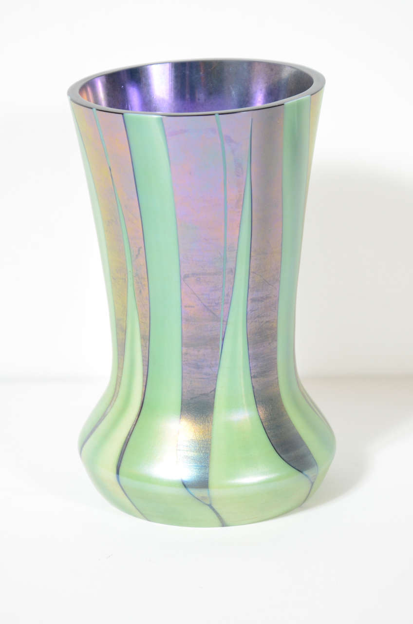 This Gorgeous Art Deco vase by Tiffany & Co. is made of superior quality glass in iridescent violet and a reed design. This piece is signed.