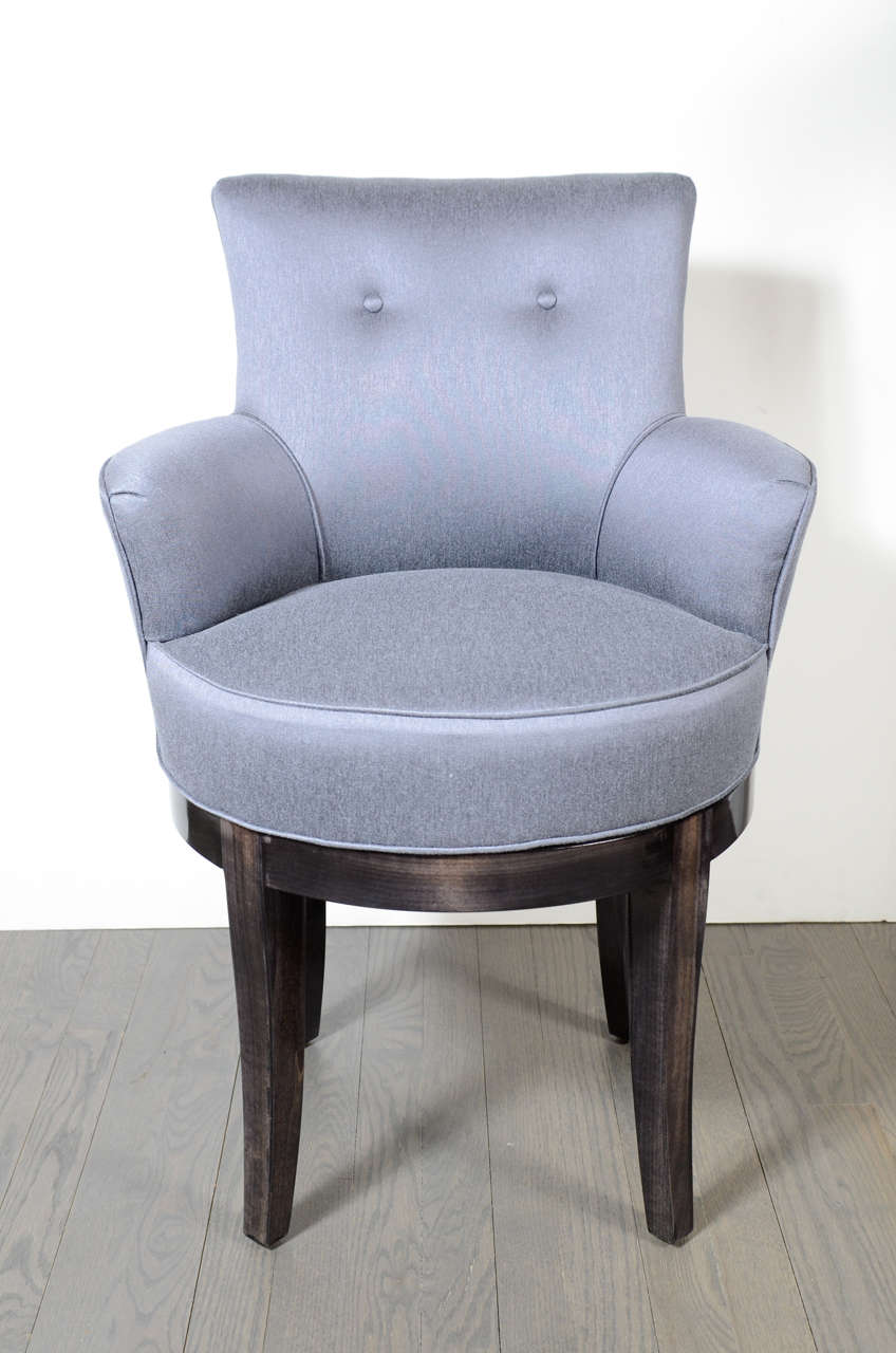 This is a gorgeous 1940s Hollywood swivel vanity chair features walnut legs and platinum blue sharkskin upholstery with buttoning detail.