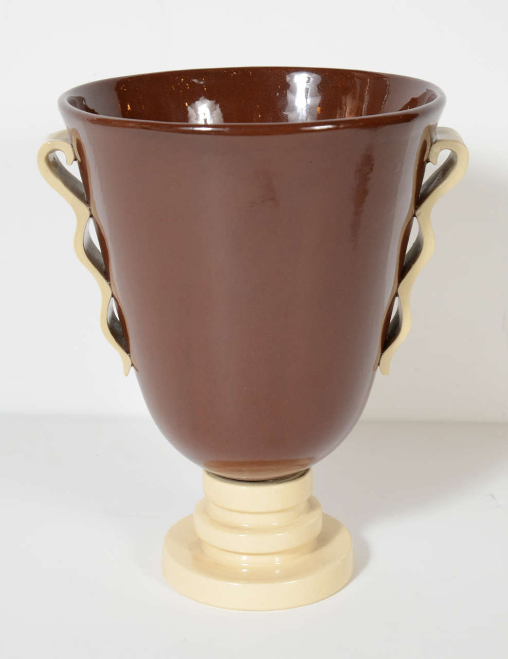 This gorgeous Art Deco urn shaped vase features a chocolate and cream glazed finish. It has a series of concentric circles forming the base and beautifully detailed handles. This piece is signed by Boch Ferre.
